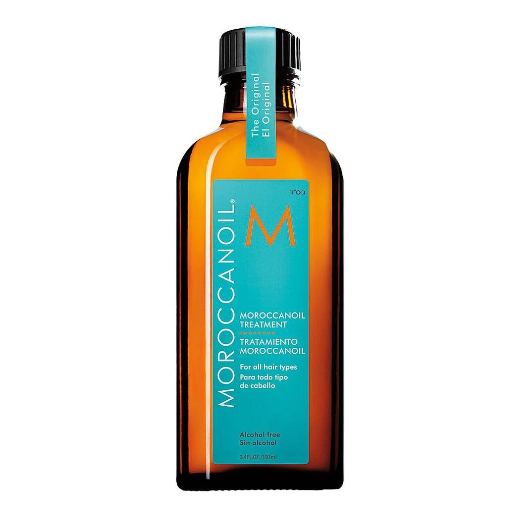 Moroccanoil Moroccan Oil Treatment in an amber glass bottle with a turquoise label and black cap, shown on a plain white background.