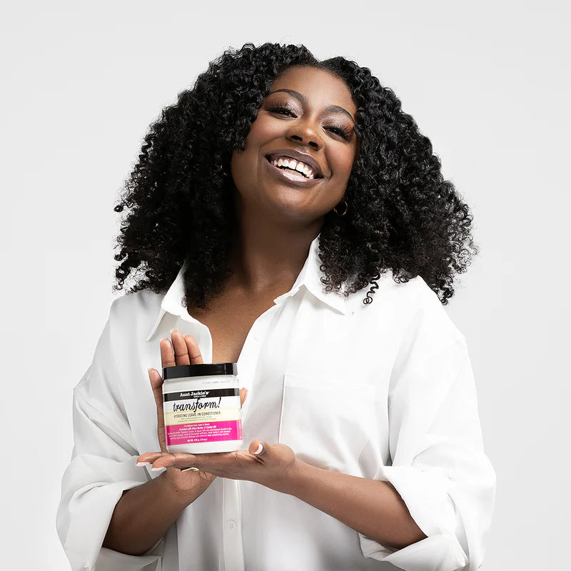 Woman holding a hair care product with a white background