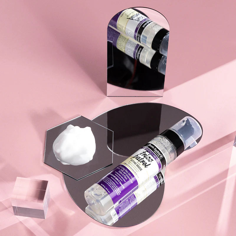 Cosmetic bottle with white cream on a pink background