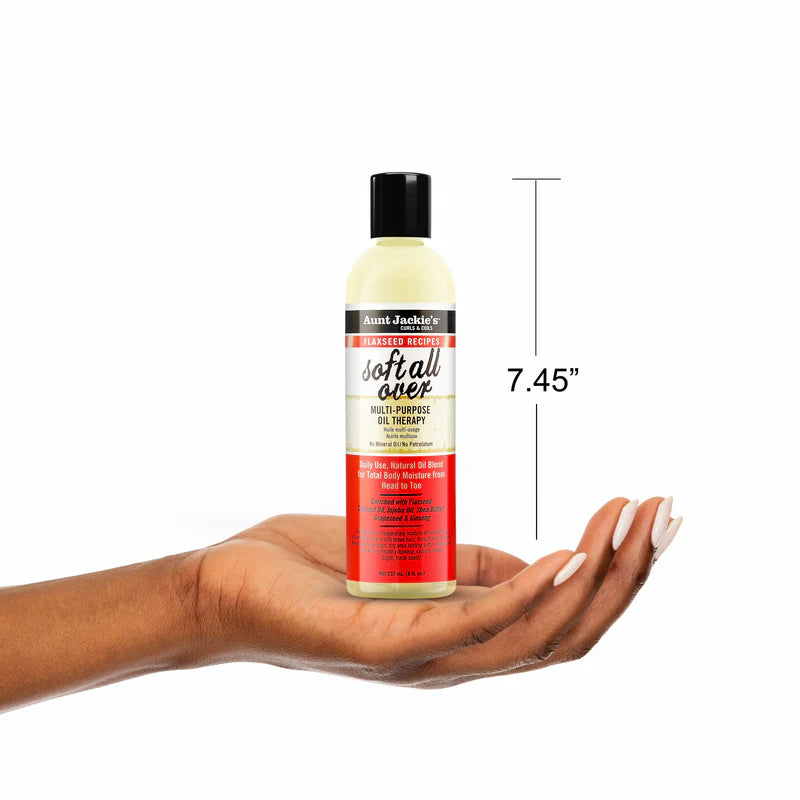 Bottle of Aunt Jackie's Soft & Silky Oil Therapy held in a hand with a measurement label on a white background