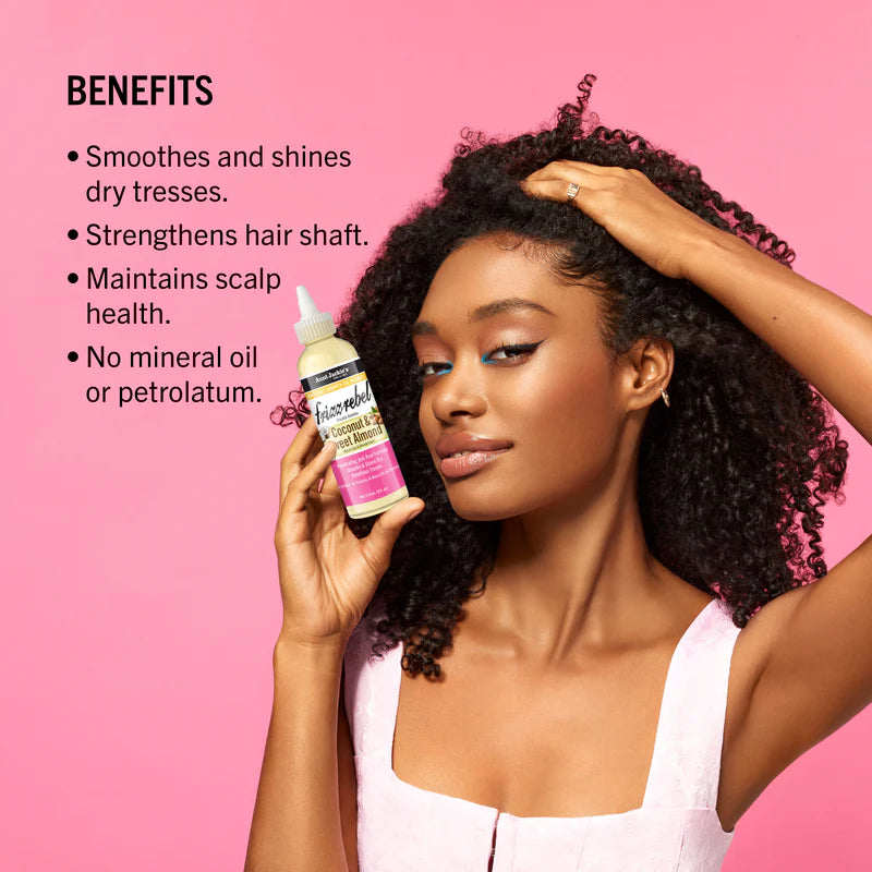 Woman holding a bottle of hair product with benefits listed on a pink background