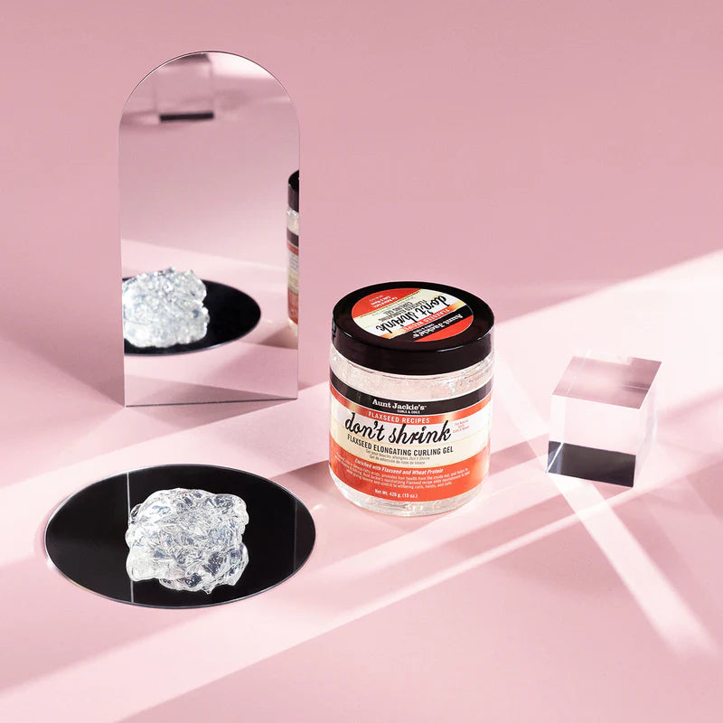 Jar of hair product with crystals on a pink background