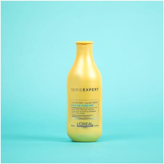 Yellow shampoo bottle with 'Serie Expert' text on a light blue background