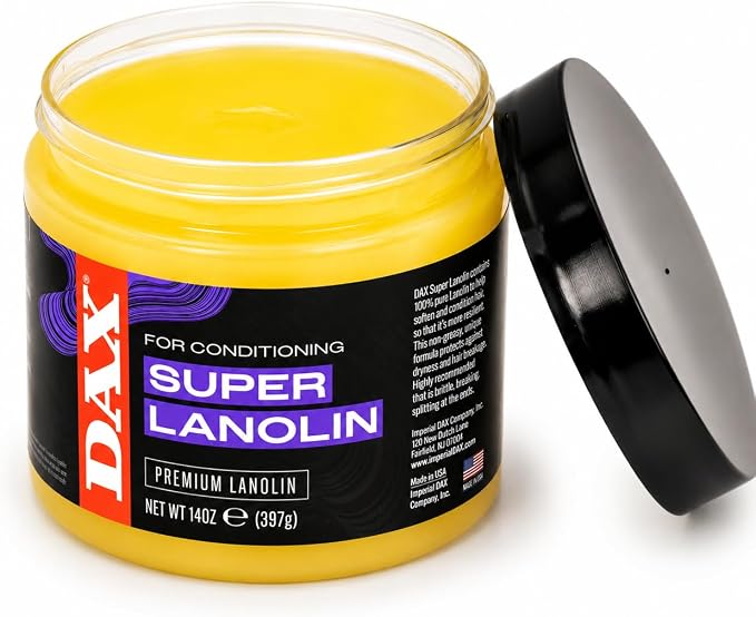 A jar of DAX Super Lanolin Premium Lanolin conditioner with a black lid leaning against it on a white background.