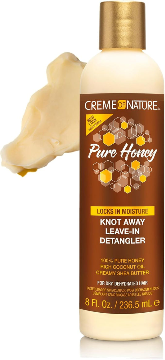 A bottle of Creme Nature Pure Honey Leave-In Detangler shown on a white background with a smear of pale honey-colored shea butter on the left side. The bottle is cream with a gold cap and a brown label featuring yellow honeycomb graphics.
