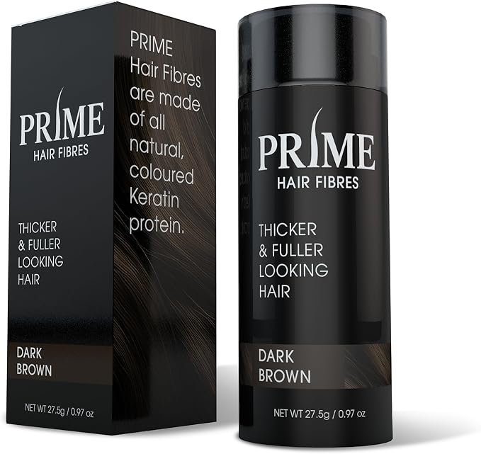 PRIME Hair Fibres Thickener & Fuller Looking Hair stick in Dark Brown, shown with its black packaging box and black cylindrical container on a white background.