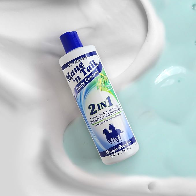 A bottle of Mane 'n' Nail Daily Control 2-in-1 Shampoo and Conditioner for horses, placed diagonally on a white ceramic sink surface with light blue soap lather.
