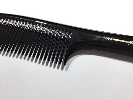 A black plastic hair comb with fine teeth and a curved handle, featuring gold lettering that reads '8.5 MICRONES' on the handle, shown on a plain white background.