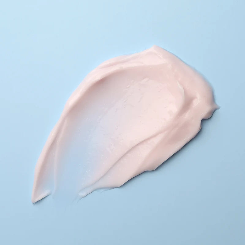 Pink cream smear on a light blue background