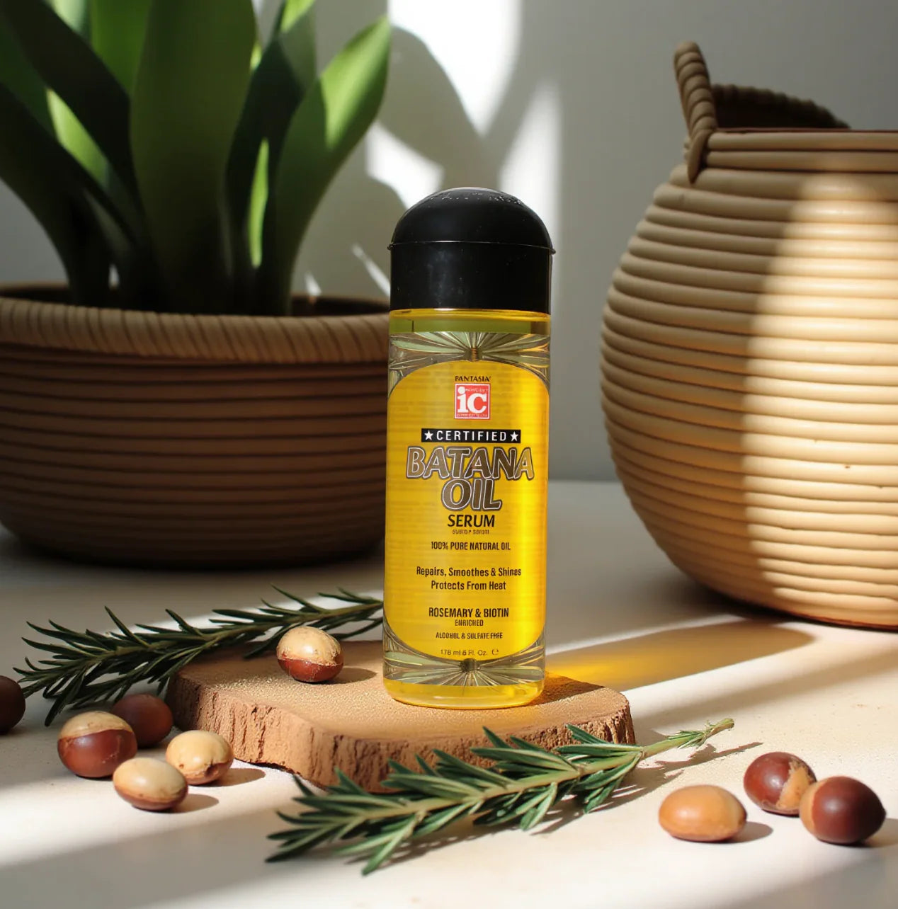 Batana Oil Serum bottle on a wooden board with nuts and leaves, natural light setting