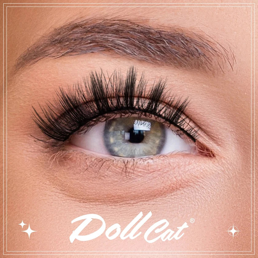 Close-up of an eye with false eyelashes and the Dollcat logo.