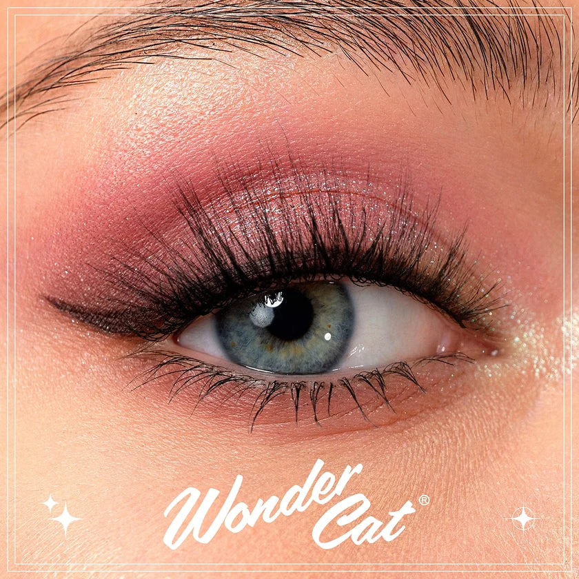 Close-up of a person's eye wearing a pink eyeshadow look with black eyeliner and long lashes. The image includes a white 'Wonder Cat' logo at the bottom.
