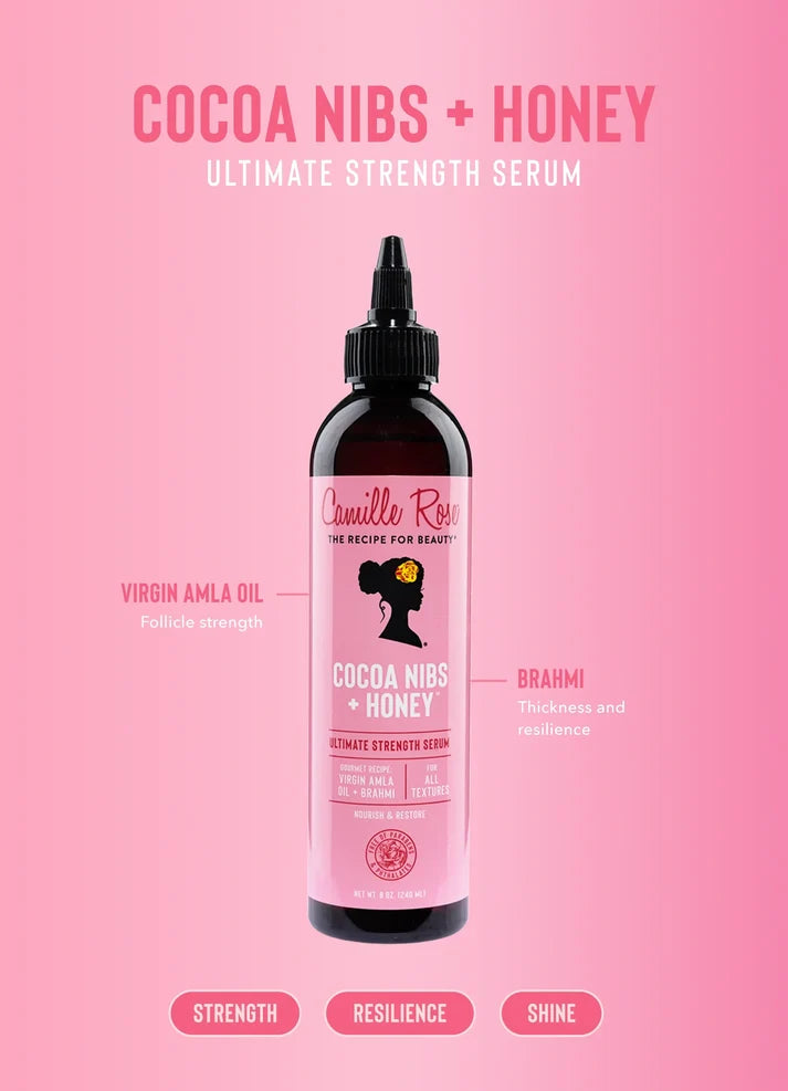 A bottle of Cruelle Roes Cocoa Nibs + Honey Ultimate Strength Serum centered on a pink background with marketing text and callouts around it.