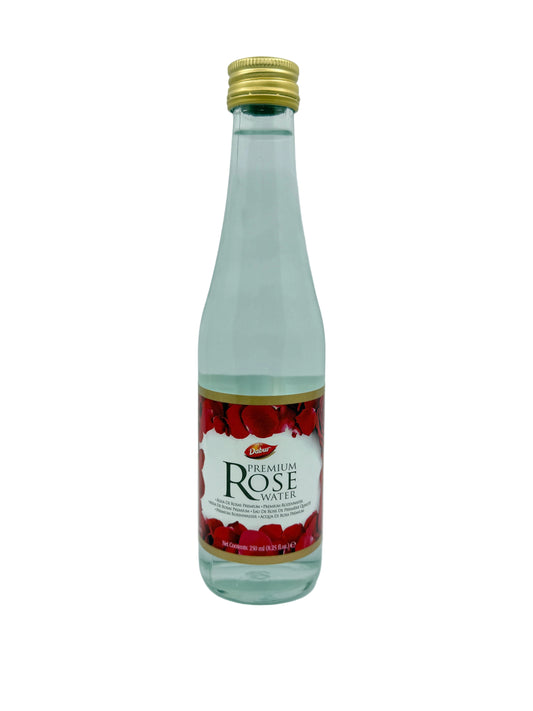 Bottle of premium rose water with a gold cap on a white background