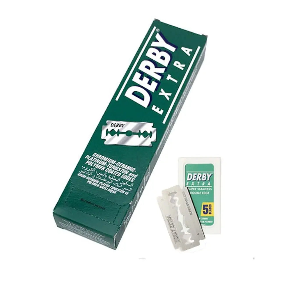 Derby Extra disposable razor box in dark green with white lettering, shown alongside two clear plastic razors and a small white card on a plain white background.