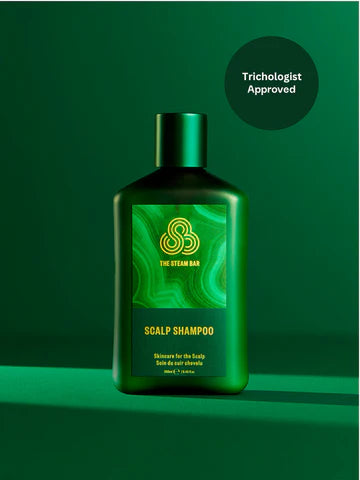 Green shampoo bottle with 'The Steam Bar' branding on a green background