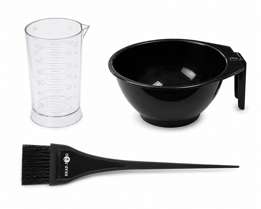 Set of hair dyeing tools including a black mixing bowl, clear measuring cup, and black brush on a white background.