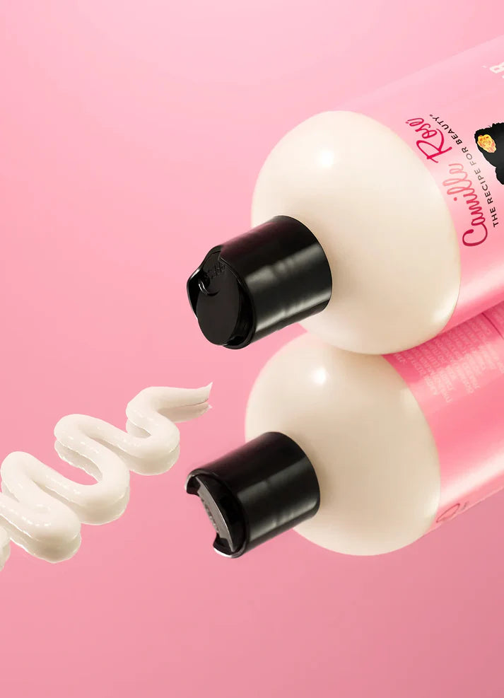 Two bottles of cream with a pink background