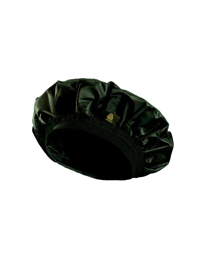 Black satin bonnet on a green background