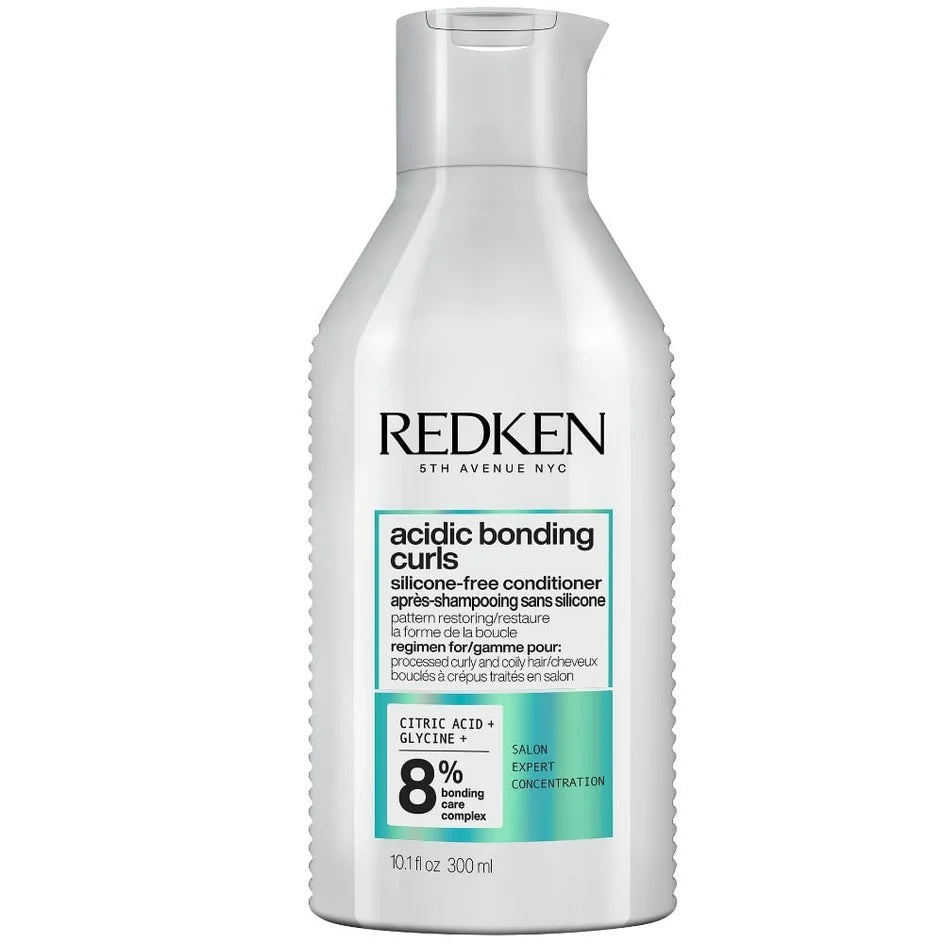Redken bottle of acidic bonding curls conditioner on a white background