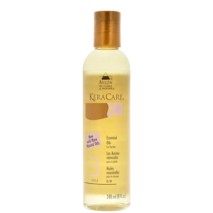 A bottle of Avlon KeraCare Essential Oils No. 3 for hair, filled with pale yellow oil and featuring a metallic gold cap, set against a plain white background.