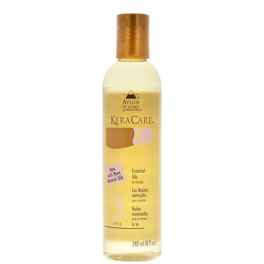 A bottle of Avlon KeraCare Essential Oils No. 3 for hair, filled with pale yellow oil and featuring a metallic gold cap, set against a plain white background.