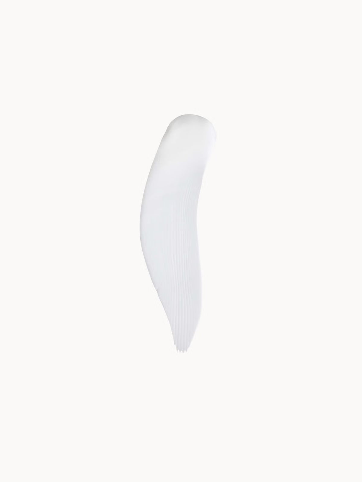 A single white cosmetic smear or swipe on a plain off-white background.