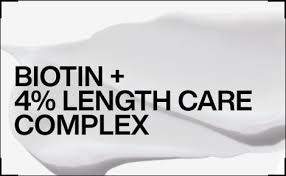 Advertisement for a hair care product with text 'BIOTIN + 4% LENGTH CARE COMPLEX' on a white background.