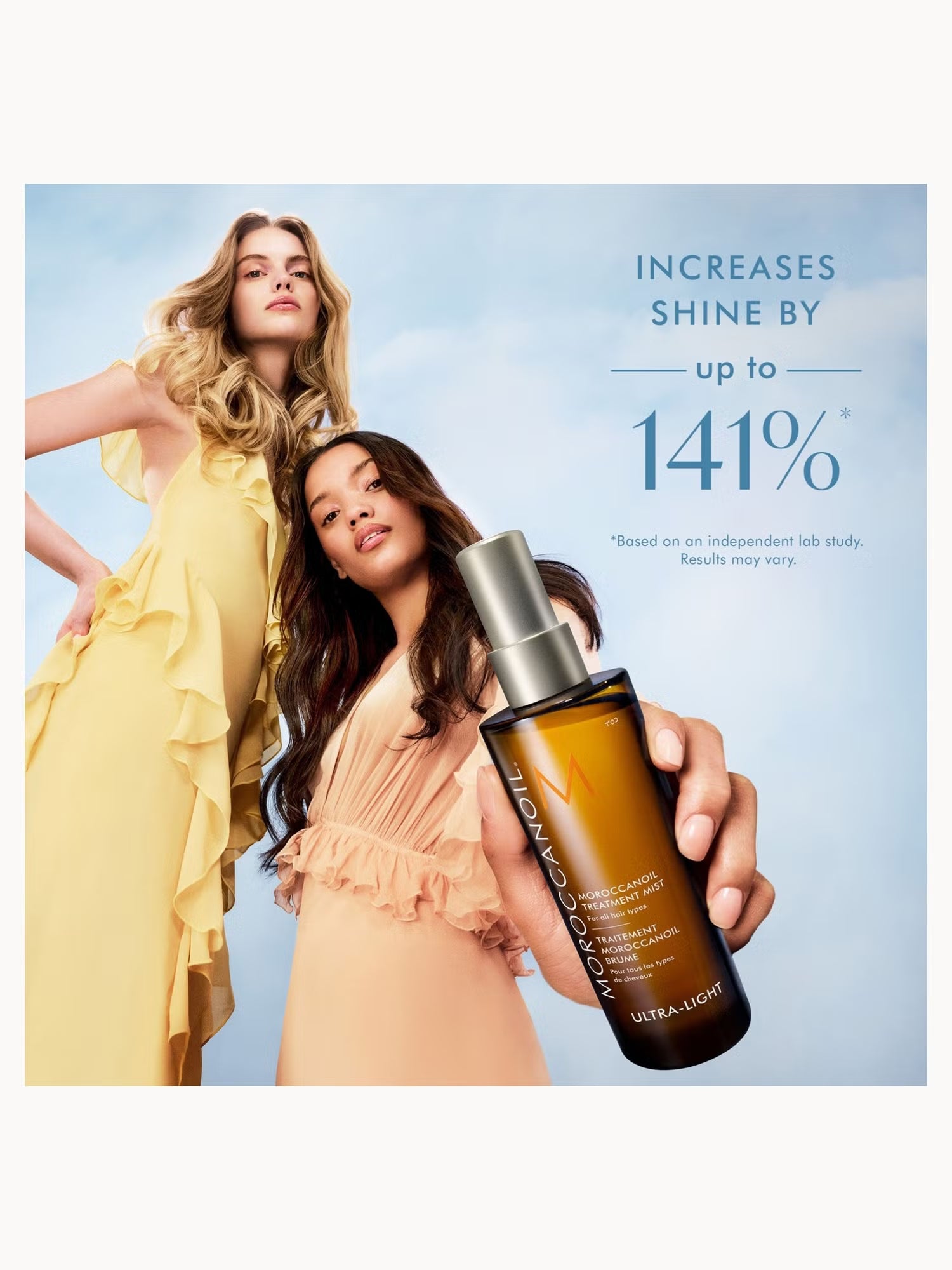 Two women with styled hair holding a bottle of hair product against a light blue background.