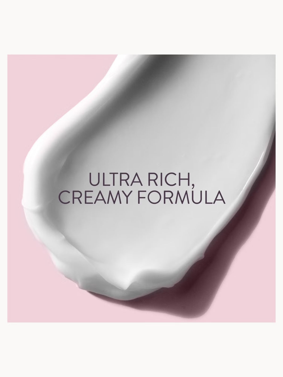 A close-up of a thick white cream smear on a soft pink background with the text 'ULTRA RICH, CREAMY FORMULA' overlaid in dark gray.