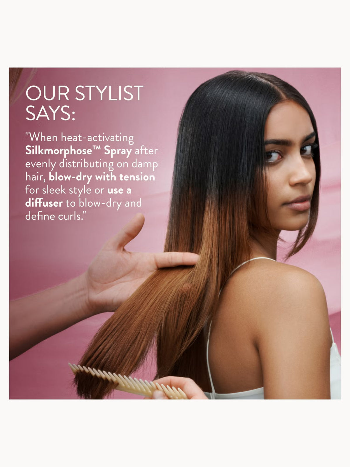 A woman with long dark brown to blonde ombre hair looks over her shoulder while a stylist's hand combs her hair. Text on the left reads, 'OUR STYLIST SAYS: "When heat-activating Silkmorphose Spray after evenly distributing on damp hair, blow-dry with tension for sleek style or use a diffuser to blow-dry and define curls.