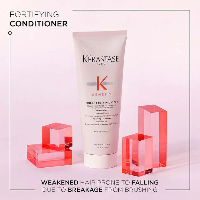 Kérastase conditioner bottle with text on a light pink background