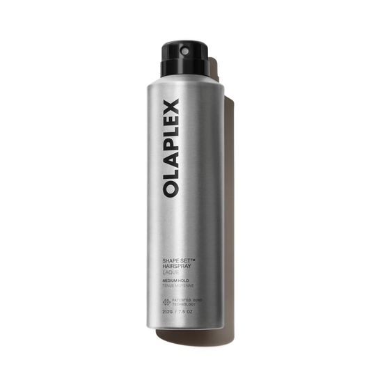 A silver aerosol can of Olaplex Shape Set Hair Spray with a black spray nozzle, shown on a clean white background with a soft shadow.