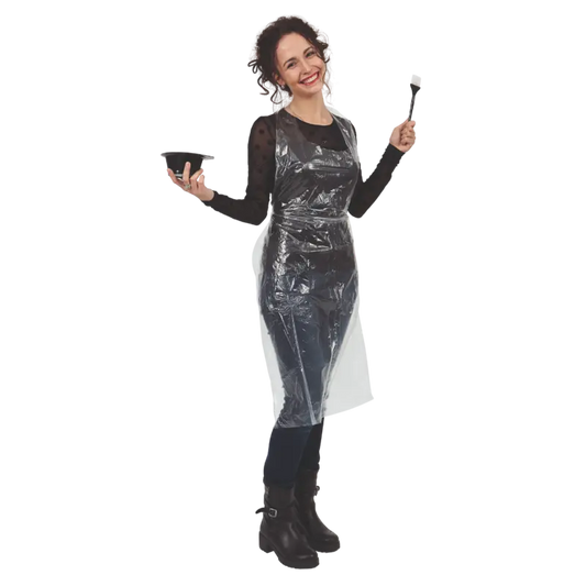 Woman wearing a clear plastic apron holding a bowl and brush on a white background