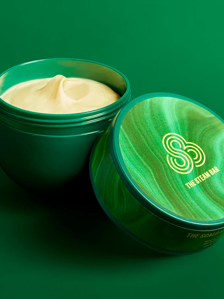 Green jar of cream with a visible brand logo on a green background